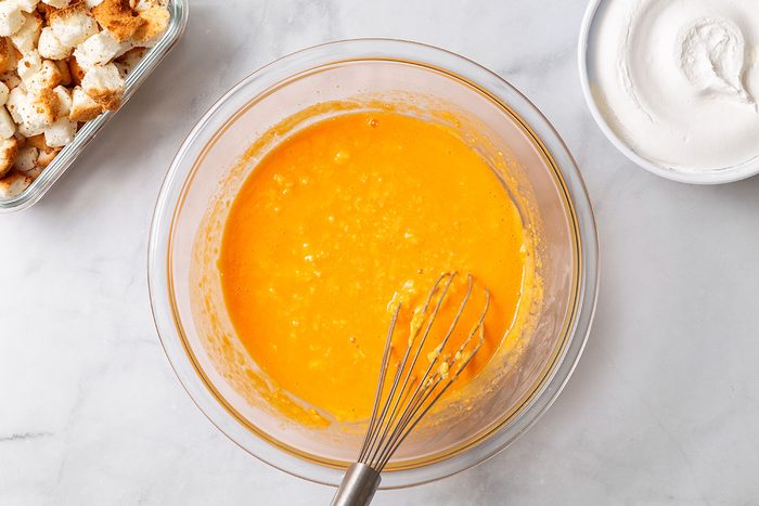 Apricot nectar, vanilla pudding mix, and milk powder whisked in a mixing bowl for step two of Apricot Delight for Taste of Home