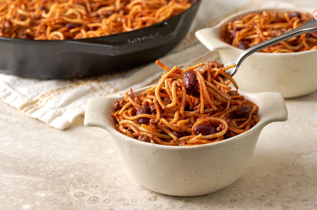 A close-up shot of the Baked Chili Spaghetti, highlighting the tender spaghetti, beans, and seasoned beef with a rich tomato sauce, by Taste of Home.