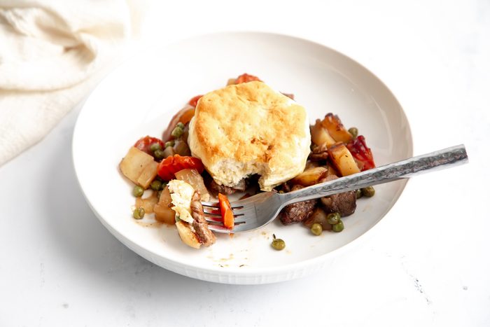 Close up shot for Taste of Home Beef Potpie with Biscuits being served on a plate.