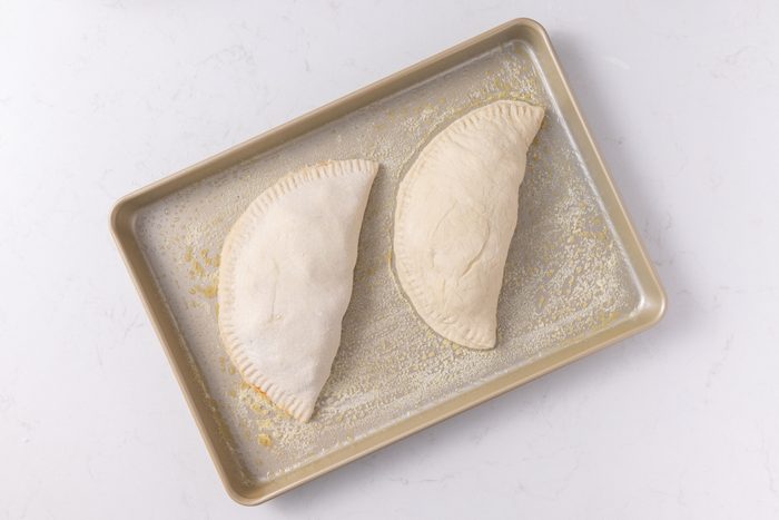 Calzones ready to go in the oven.