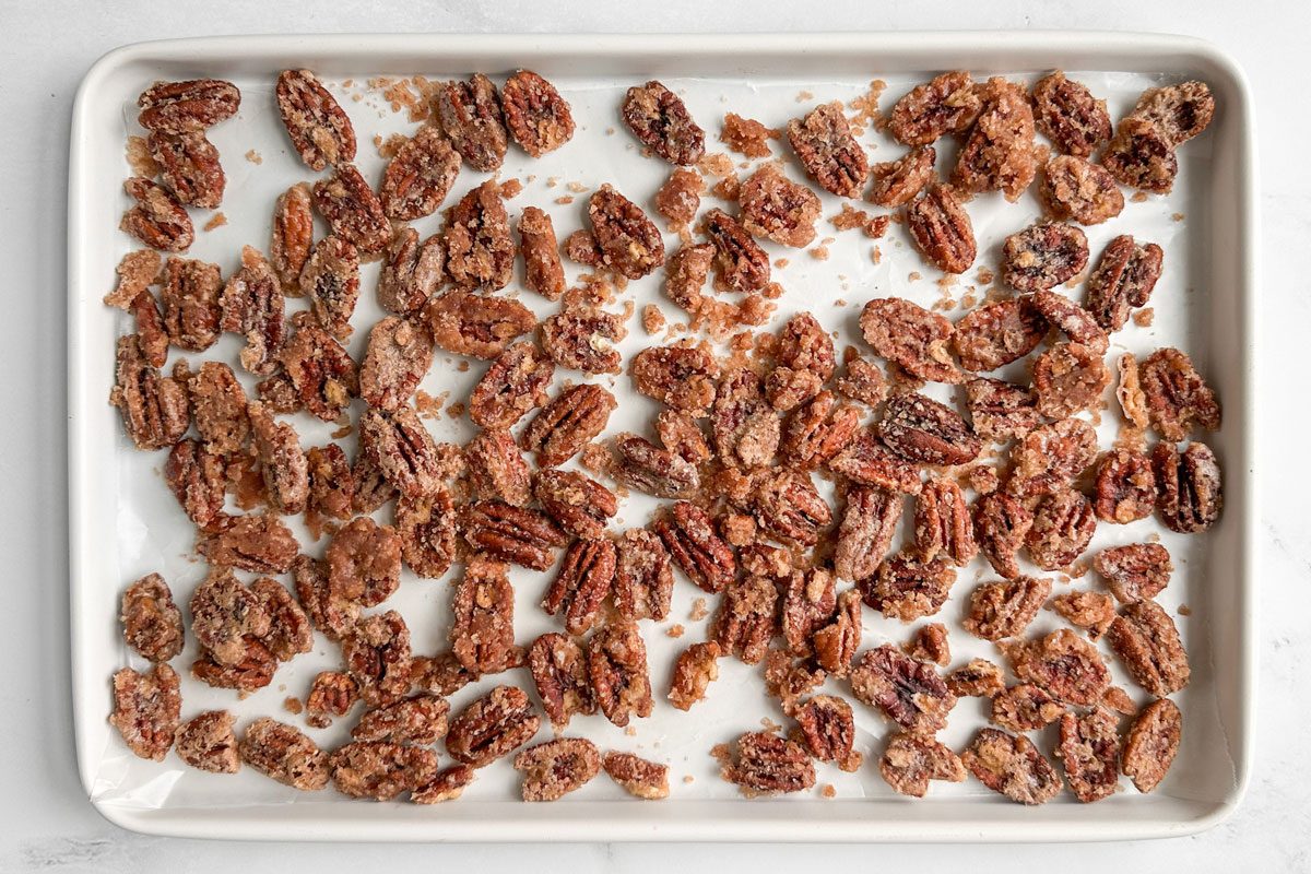 Taste of Home Candied Pecans on a white baking sheet
