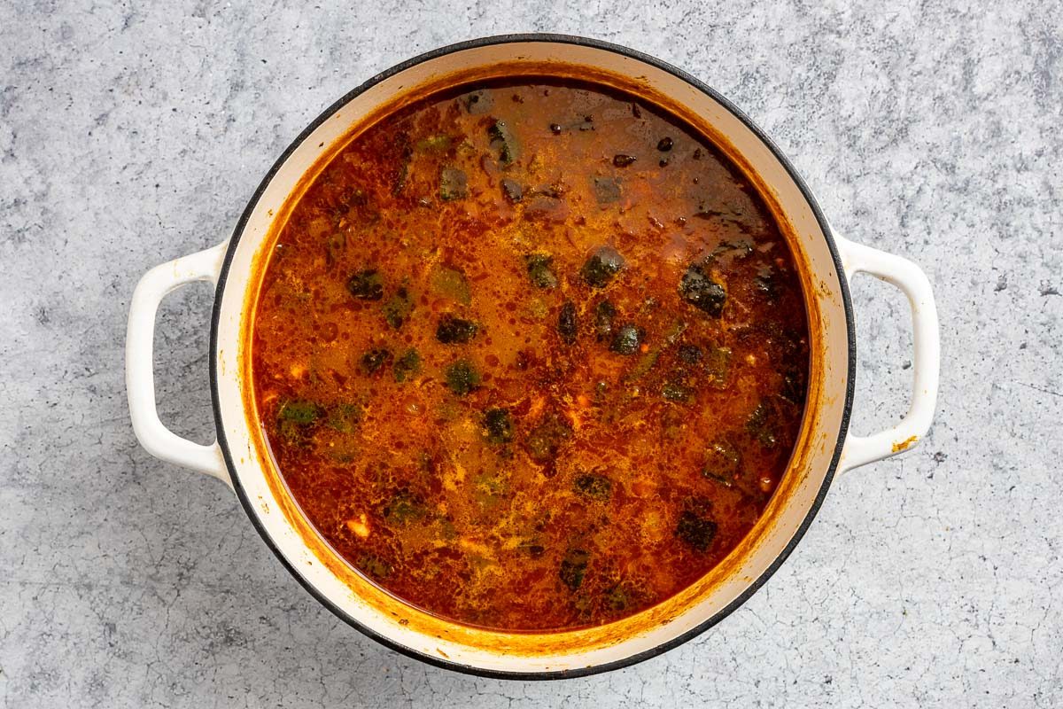 Taste of Home Chicken Poblano Soup photo of the sauces, corn, broth, and beans added to the Dutch oven.