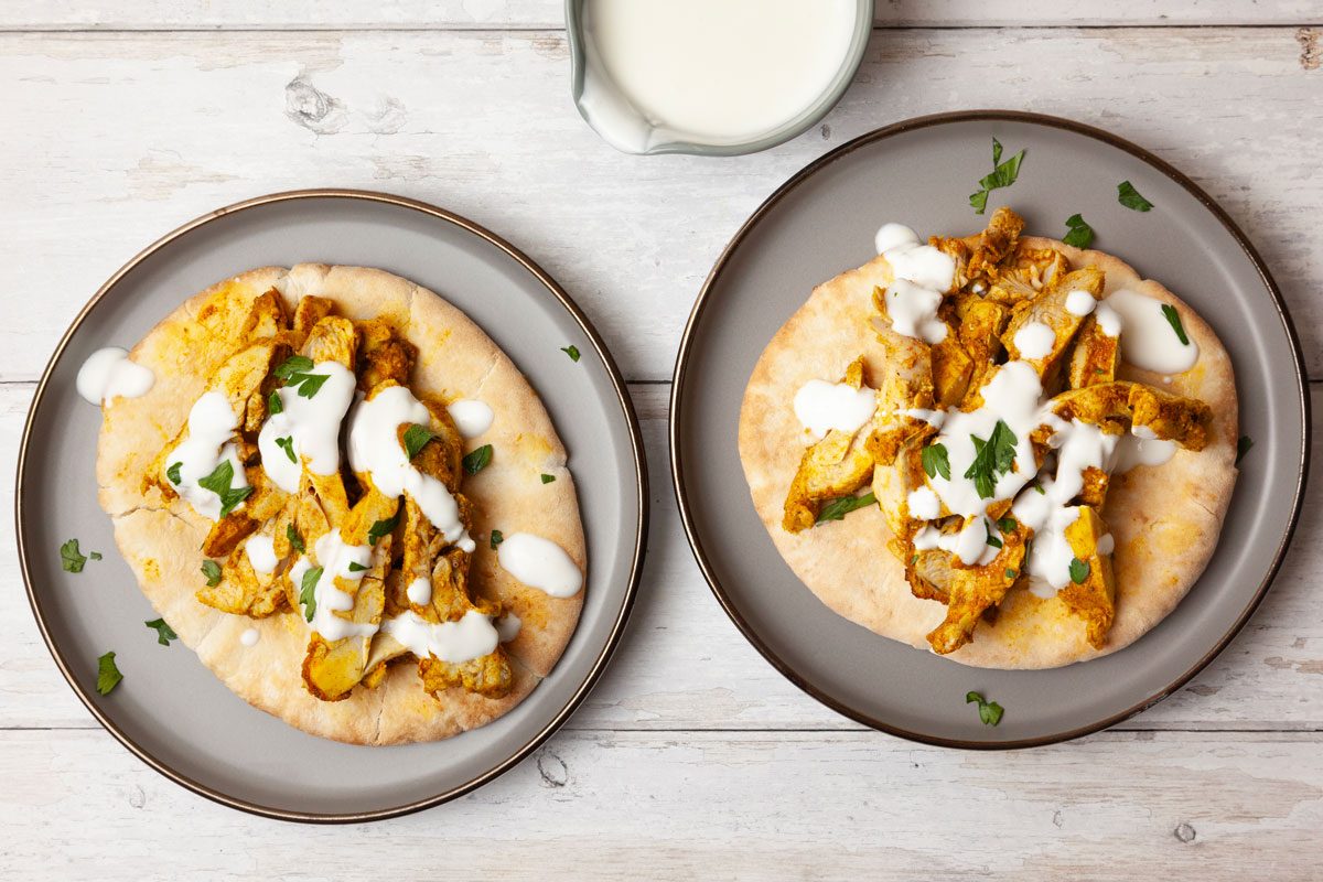 Two single servings of Taste of Home Chicken Shawarma with yogurt sauce