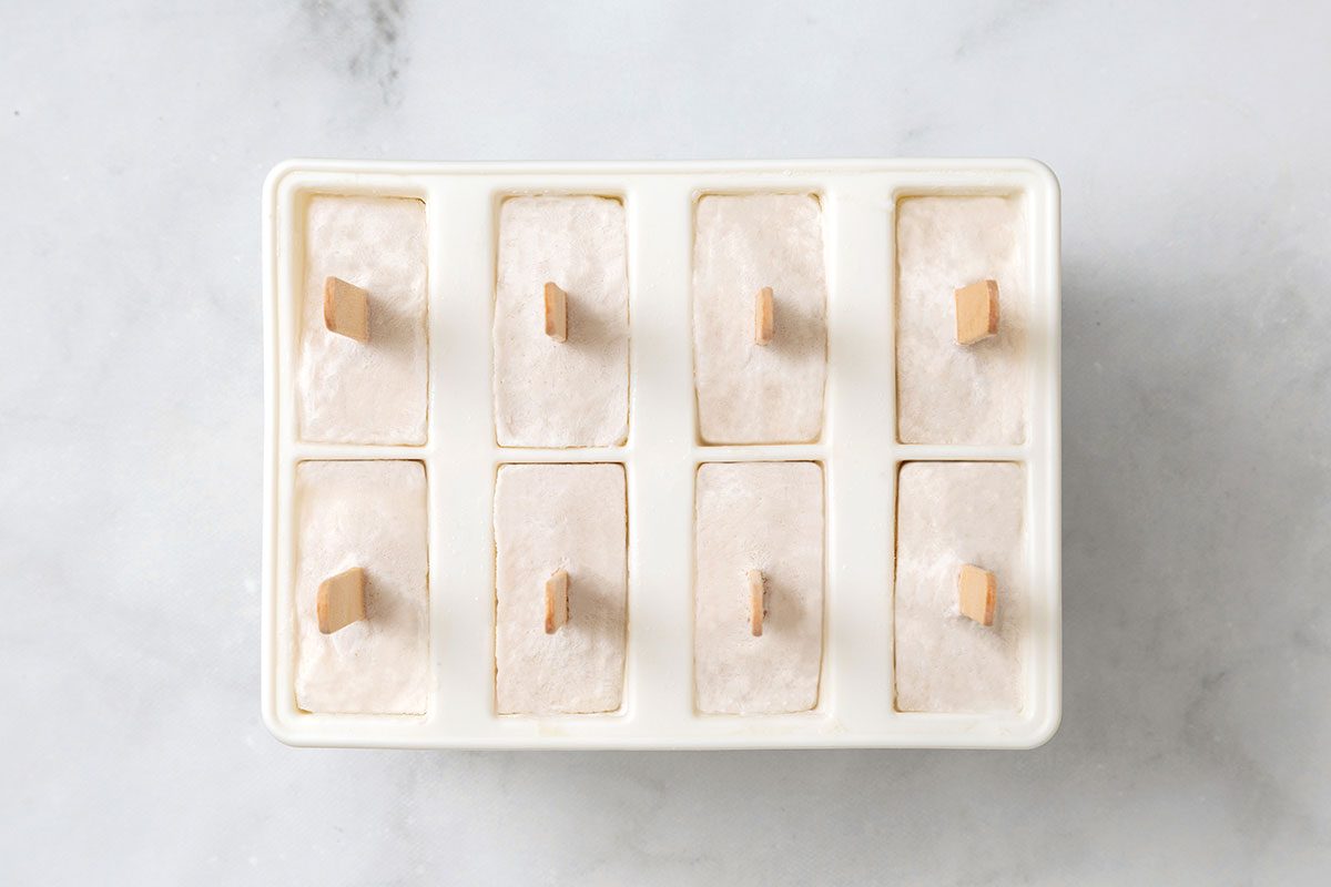 Solid coconut popsicles in molds for step 3 in Coconut Popsicles for Taste of Home
