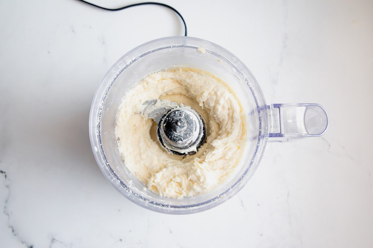 Overhead shot for Taste of Home Coconut Snowballs, coconut snowball mixture after being pulsed in a food processor.