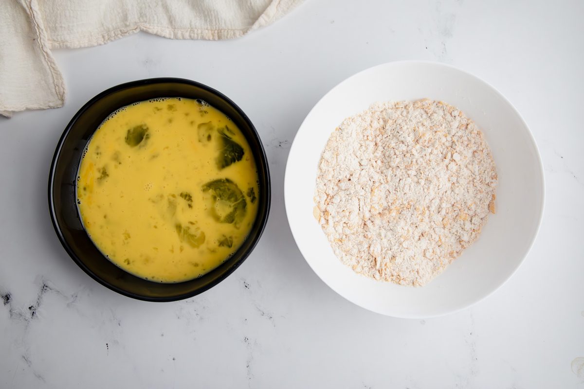 Overhead shot for Taste of Home Cornflake Chicken, wet and dry ingredients in a bowl.