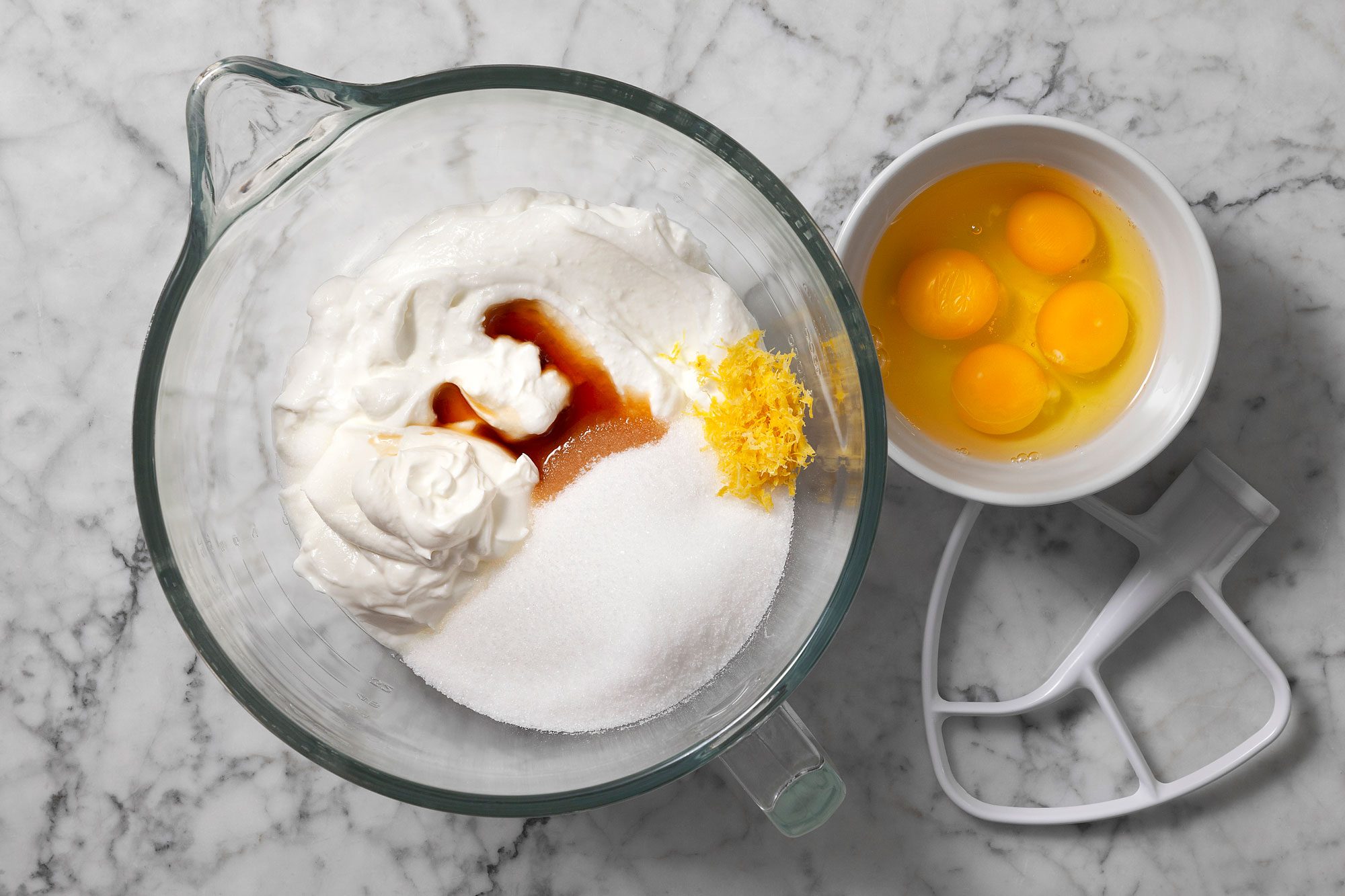 Transfer to the bowl of a stand mixer fitted with a paddle attachment. Add yogurt, sugar, lemon zest, vanilla and salt