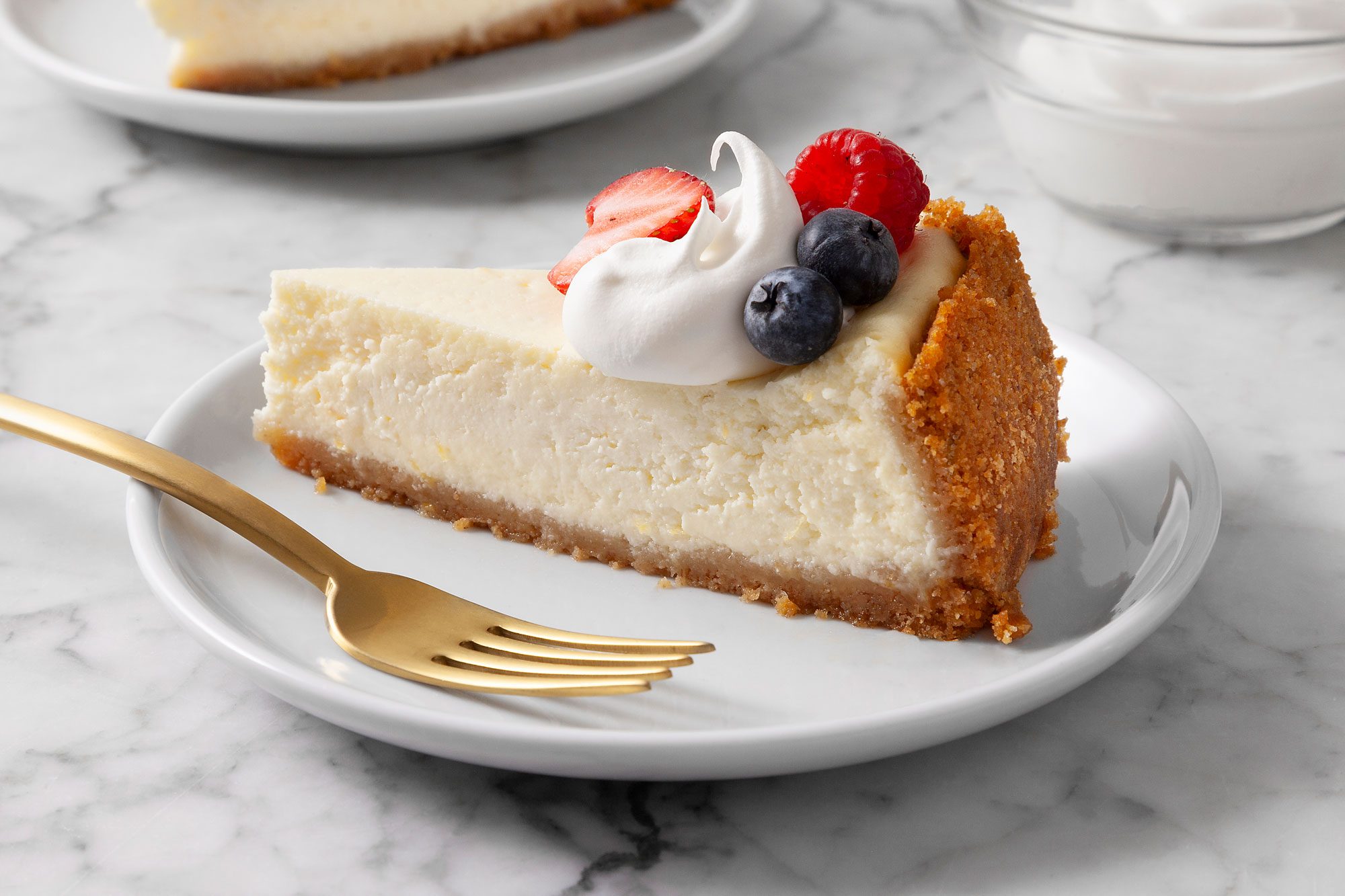 3/4th shot of cottage cheese cheescake slice topped with mixed berries