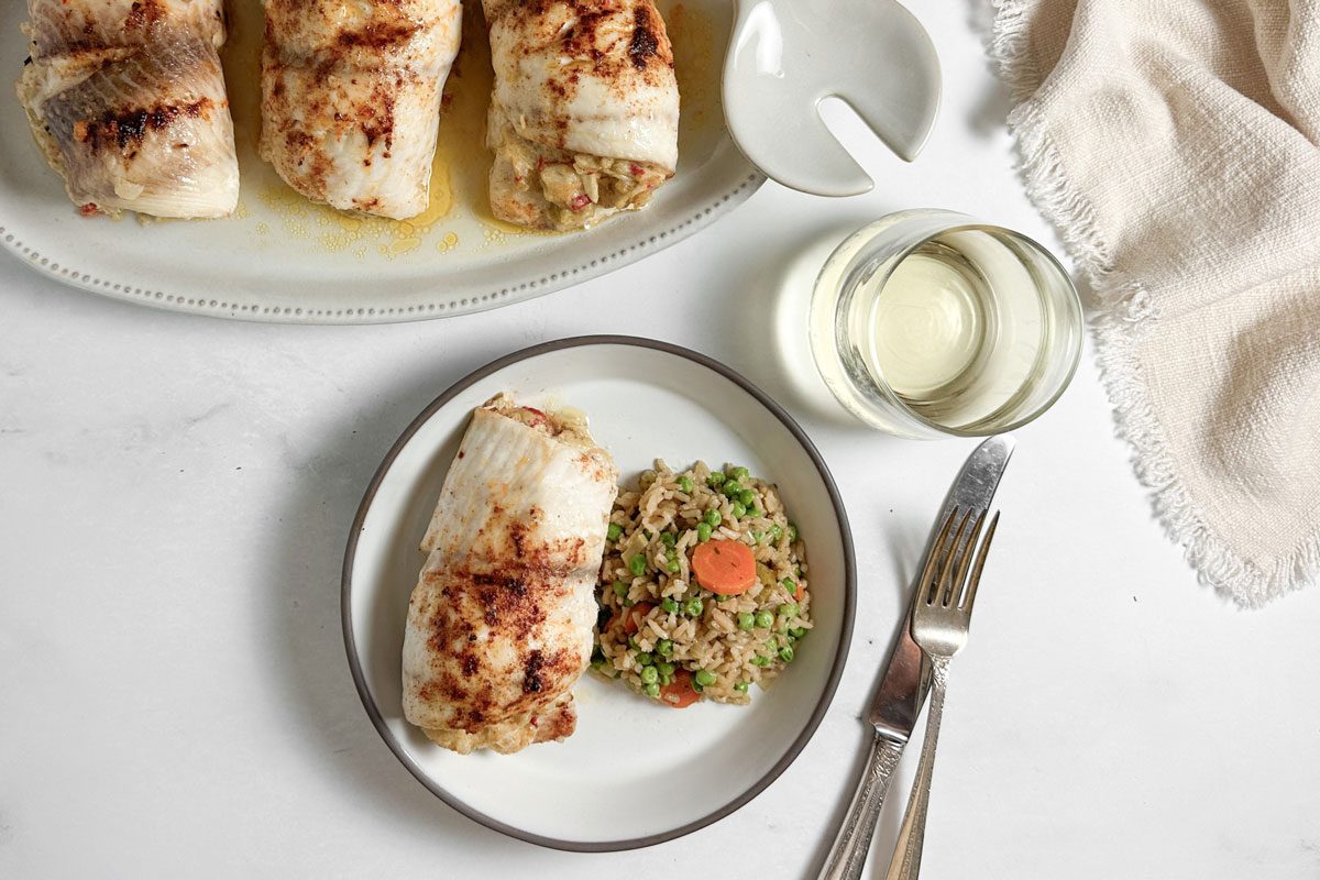 Taste of Home Crab Stuffed Tilapia on a ceramic plate with rice