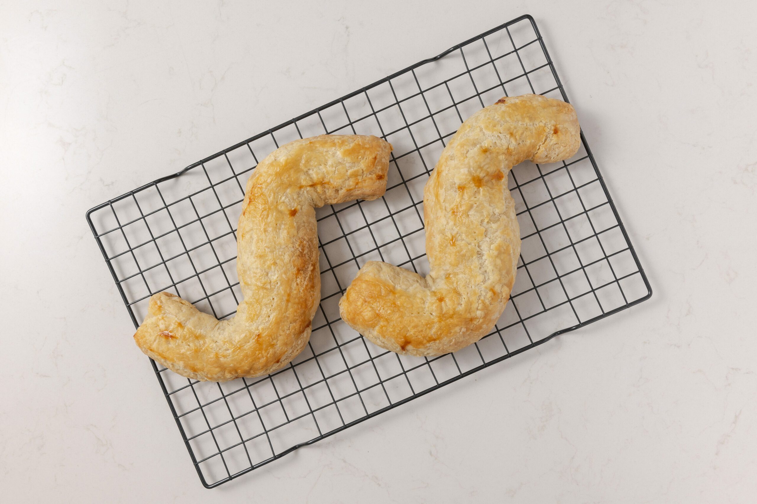 Dutch letters baked, cooling on wire rack.