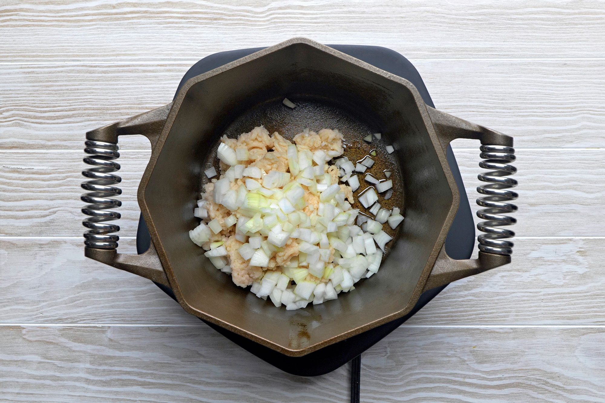 Heat oil In a large pan then add chicken and onion and cook over medium-high heat until chicken is no longer pink