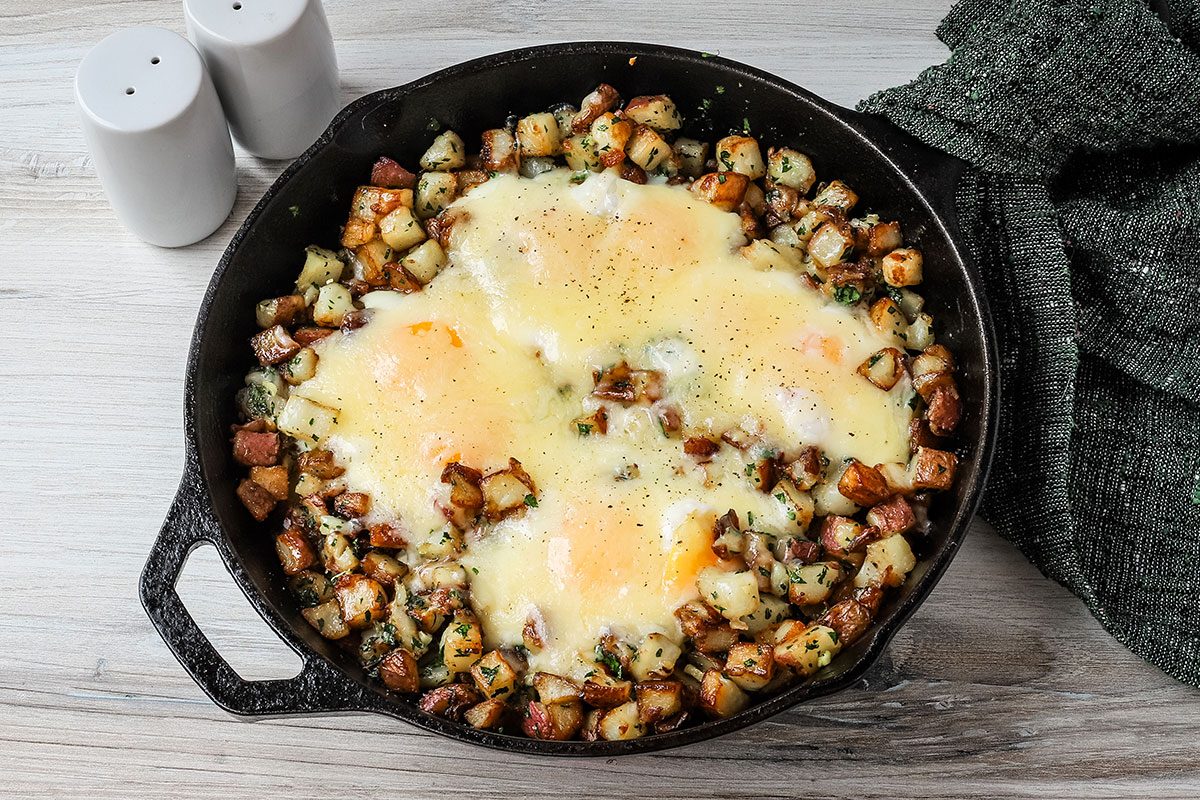 Potatoes and eggs with a cheddar cheese topping, ready to enjoy.