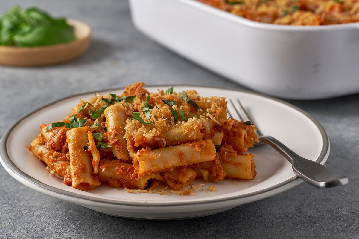 A close-up shot of the Five-Cheese Ziti's crispy topping, revealing the melted mozzarella and crunchy panko crust.