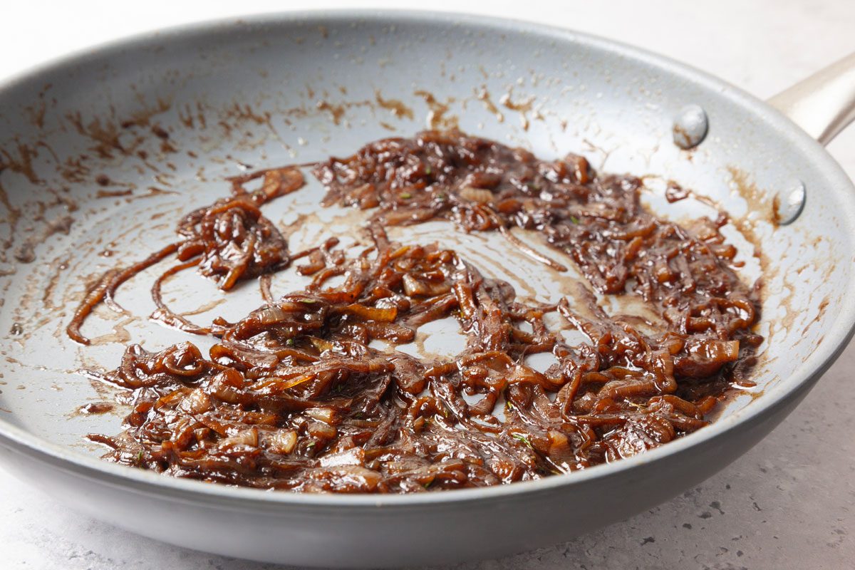 Step 1 of Taste of Home French Onion Meatballs is to melt 1 tablespoon butter over medium-low heat. Add the onions and stir to coat. Cook until onions begin to caramelize and are very soft, stirring occasionally, about 15 to 20 minutes. Stir in 1/2 teaspoon salt, 1/2 teaspoon pepper and rosemary. Add the wine; cook until it has evaporated, 2 to 3 minutes, stirring constantly.