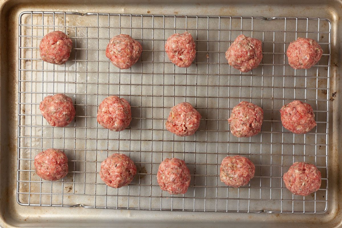 Step 3 of Taste of Home French Onion Meatballs is tocombine ground beef, bread crumbs, egg, parsley, garlic, Italian seasoning, remaining 1 teaspoon salt and remaining 1/2 teaspoon pepper. Form the mixture into 24 meatballs and place them on the prepared pan. Bake them until their internal temperature reaches 165°, about 15 to 20 minutes.