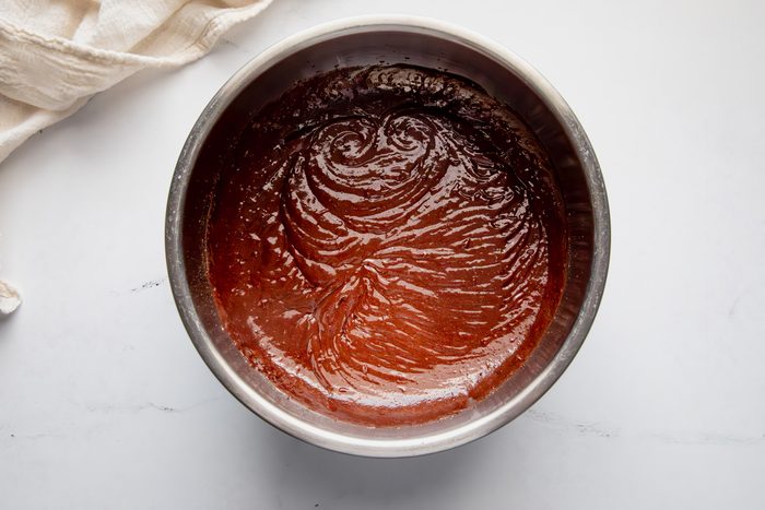 Overhead shot for Taste of Home Fudge Pie, fudge filling in a metal bowl.