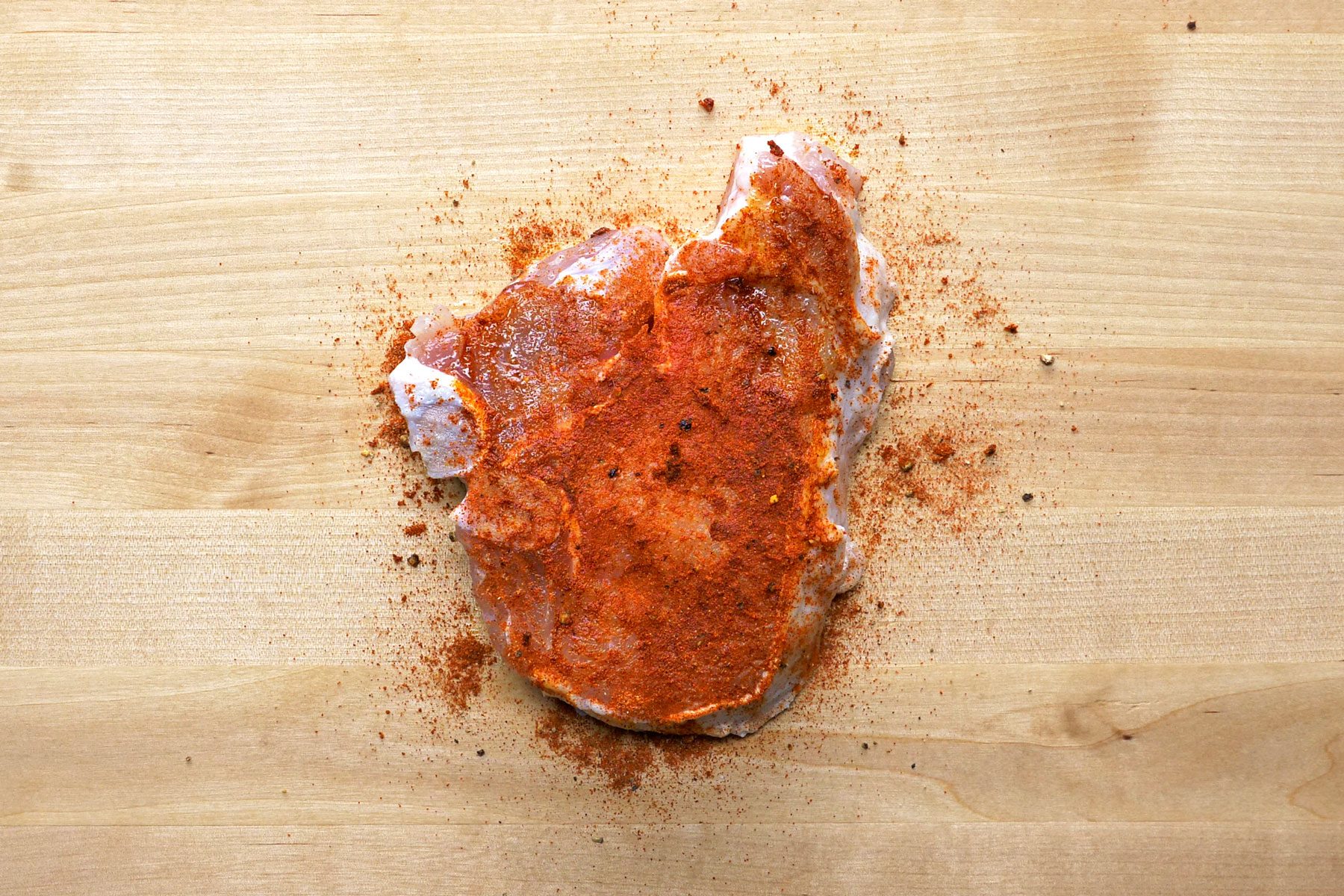 Spice mix rubbed onto pork chops.
