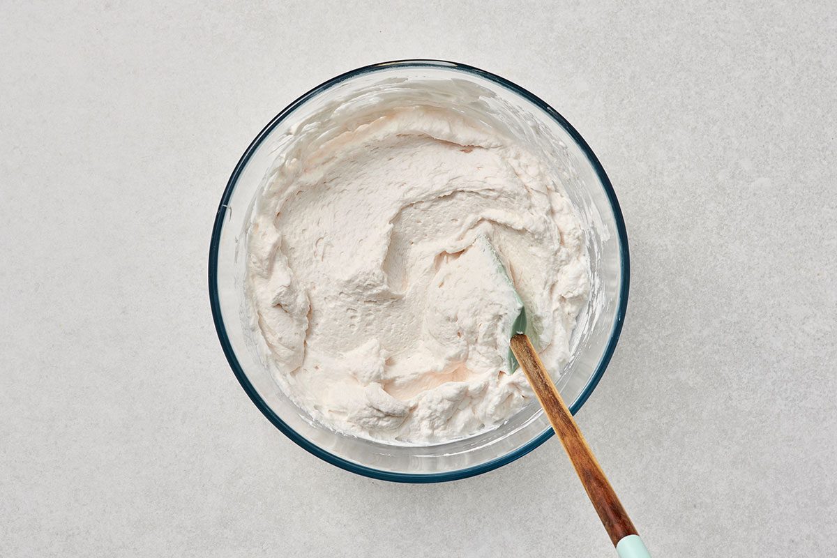 All ingredients combined in a bowl with a spatula