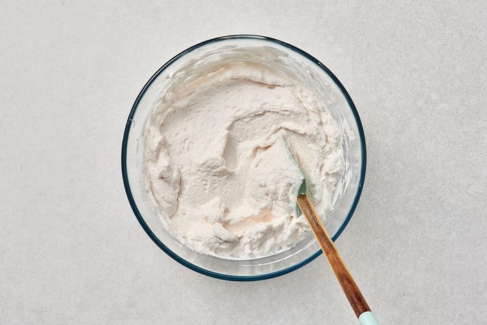 All ingredients combined in a bowl with a spatula