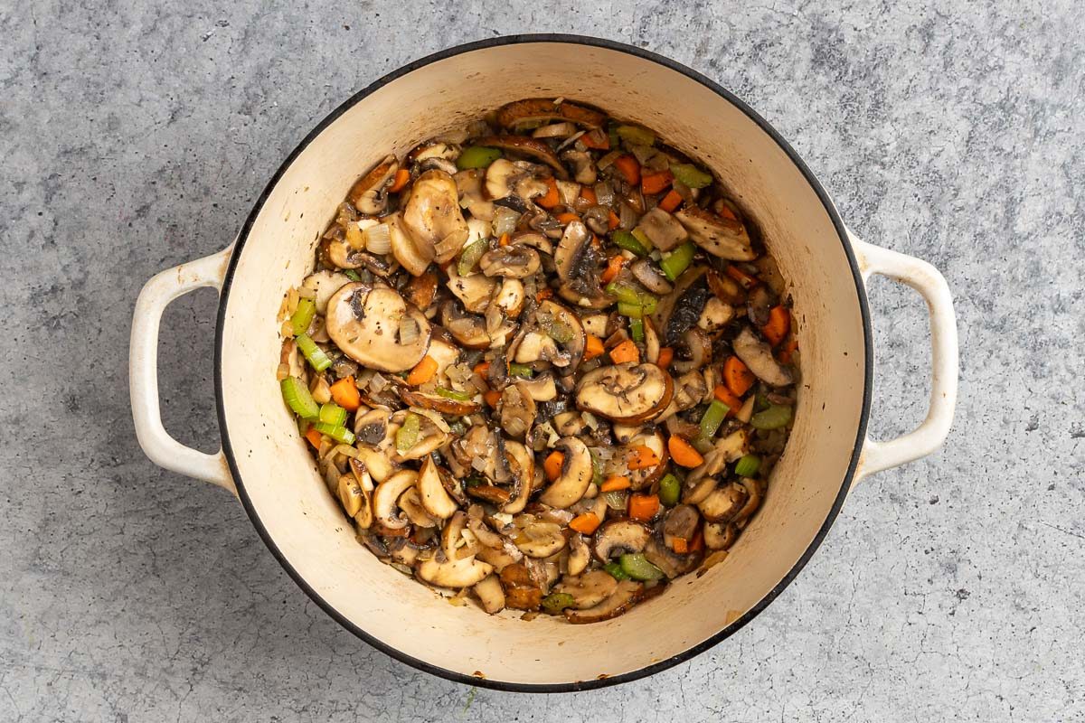 Taste of Home Mushroom Barley Soup reciped photo of adding the mushrooms and seasonings.