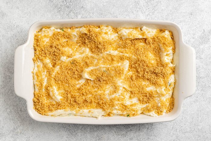 Taste of Home Party Mashed Potatoes photo of mixed and seasoned potatoes in a casserole dish.