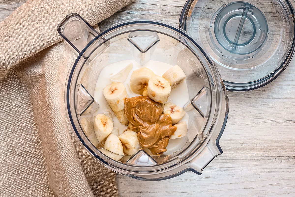 Peanut butter smoothie preparation in the blender.