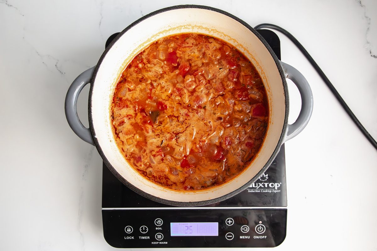 Overhead shot for Taste of Home Pinto Bean Soup, with soup ingredients cooking in a large dutch oven.