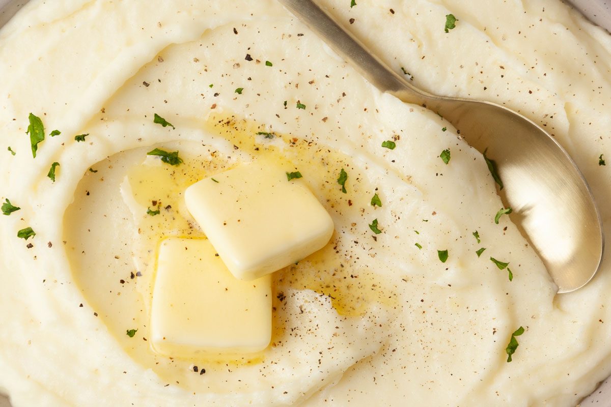 Close up of full yield of Taste of Home Potato Puree toped with butter, pepper and parsley