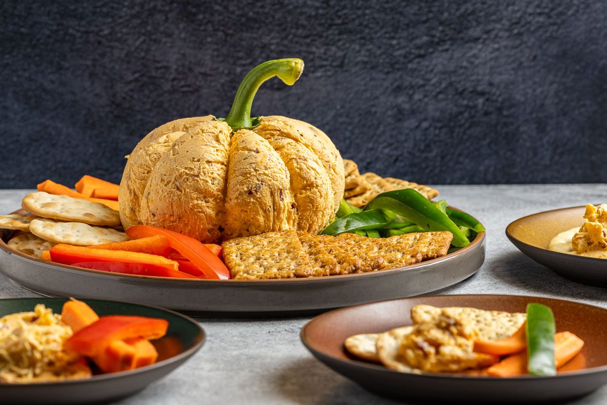 Taste of Home Pumpkin Cheese Ball photo of the finished recipe served with crackers and fresh vegetables.