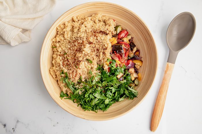 Overhead shot for Taste of Home Quinoa with Vegetables, ingredients in bowl before being mixed together.