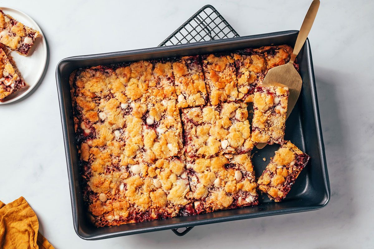 Raspberry bars with coconut cooled in a baking pan on cooling racks, cut into bars, recipe by Taste of Home