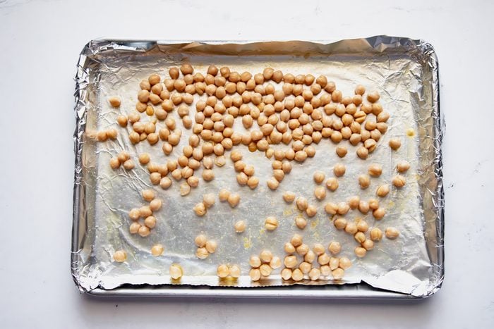 Overhead shot for Taste of Home Roasted Chickpea Salad with chickpeas on a prepared baking sheet.