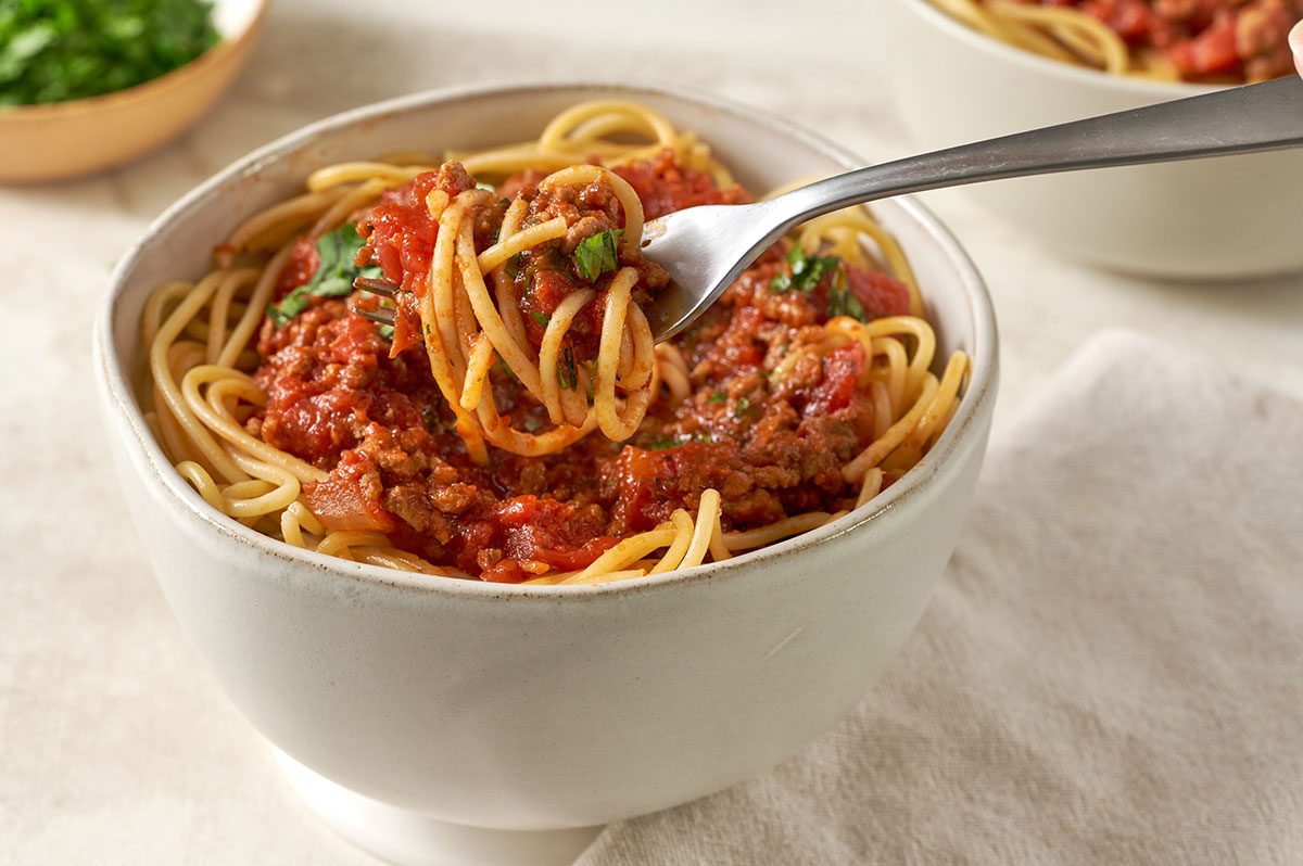 spaghetti; salsa sauce; beef; cilantro; Mexican fusion; Italian fusion; dinner plate