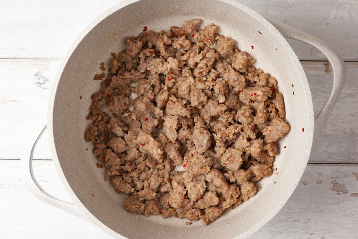 Step 2 of Taste of Home Sausage Mac and Cheese is to melt the butter over medium heat. Add the sausage and cook until it's no longer pink; for about four to five minutes, breaking it into crumbles. Drain. Remove the sausage with a slotted spoon and set aside.