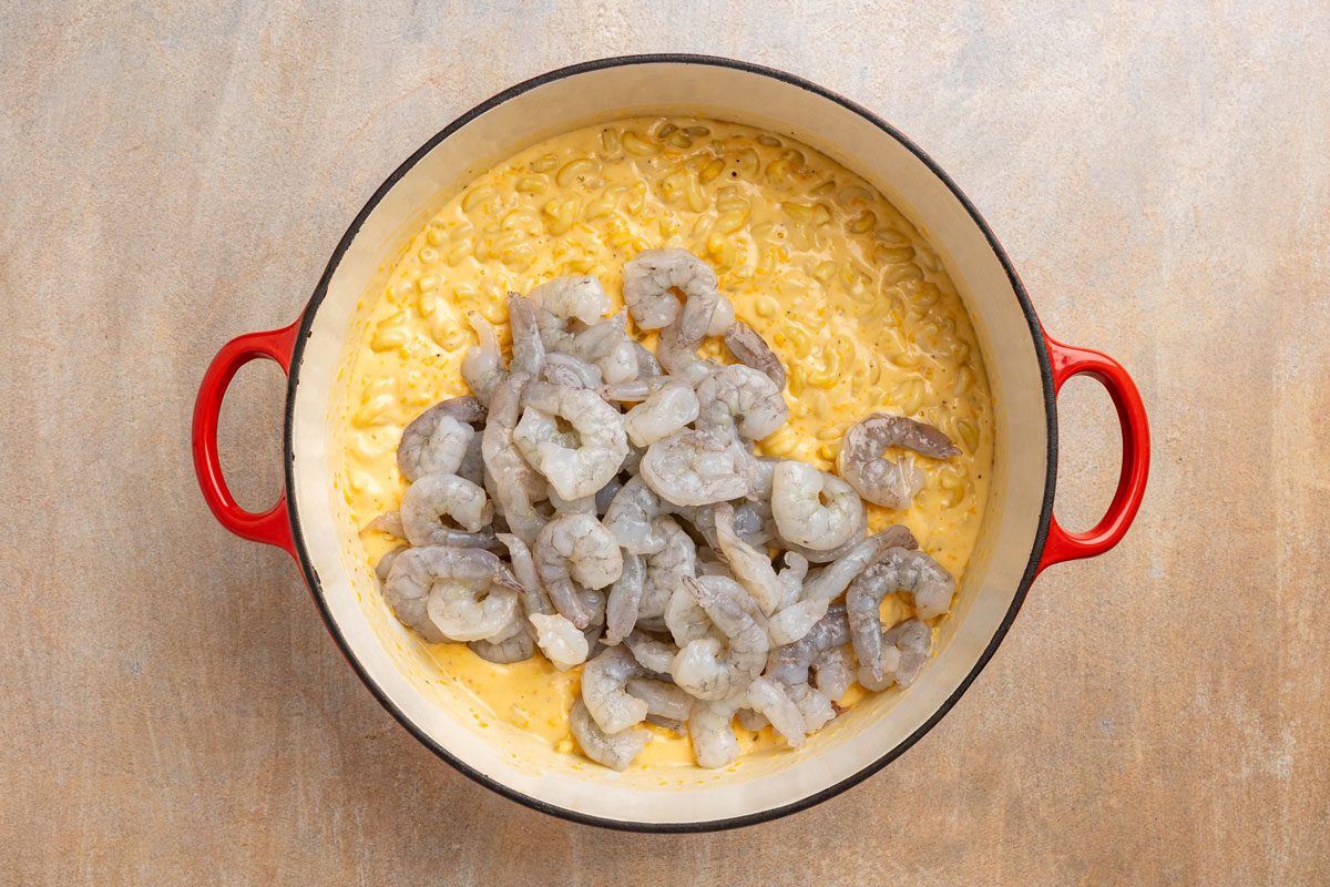 cheese sauce added to the cooked macaroni and fresh shrimp added to the pot.