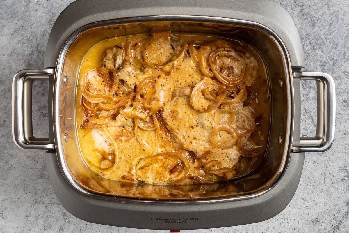 Taste of Home Slow Cooker Pork Chops and Potatoes photo of the sauce and pork chops added and cooked in the slow cooker.