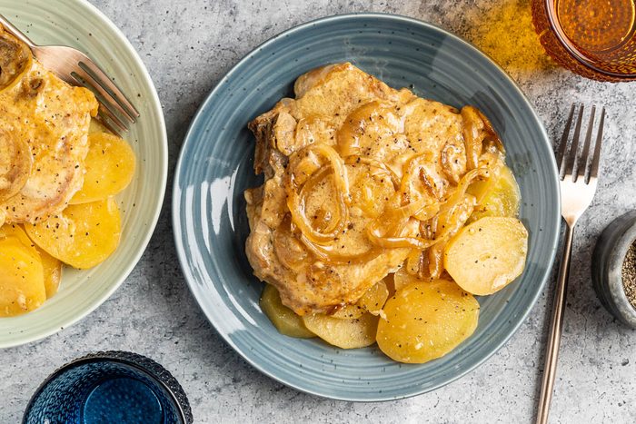 Taste of Home Slow Cooker Pork Chops and Potatoes photo of the finished recipe served on plates.
