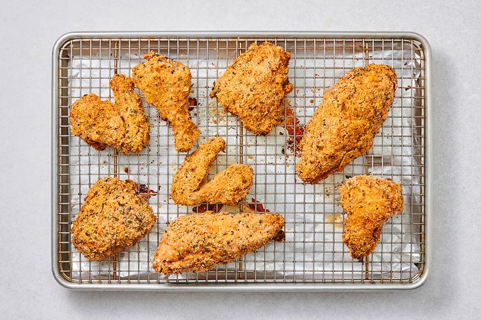 Cooked chicken cuts on a rack