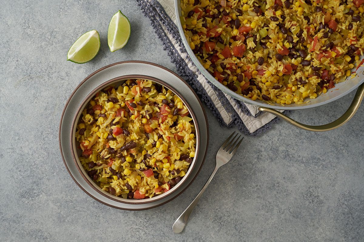 Overhead view of the finished Taste of Home Southwest Rice, showing fluffy rice mixed with black beans, corn, and diced tomatoes with green chiles.