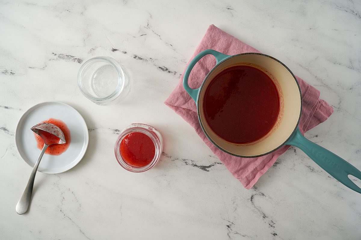 The final step shows the strawberry syrup cooling in the saucepan after being removed from the heat. The rich, thick syrup is ready to be served warm or transferred to a glass jar for refrigeration, by Taste of Home.