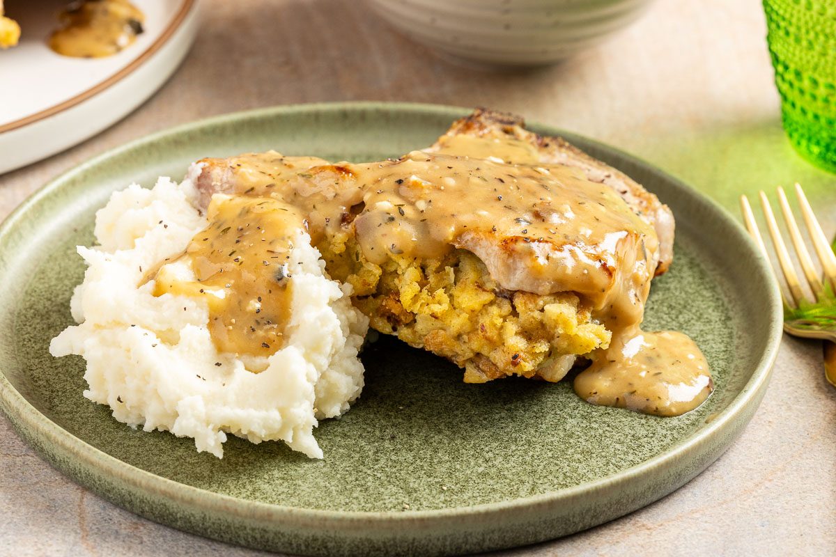 Stuffed Pork Chop on a plate with mashed potatoes 