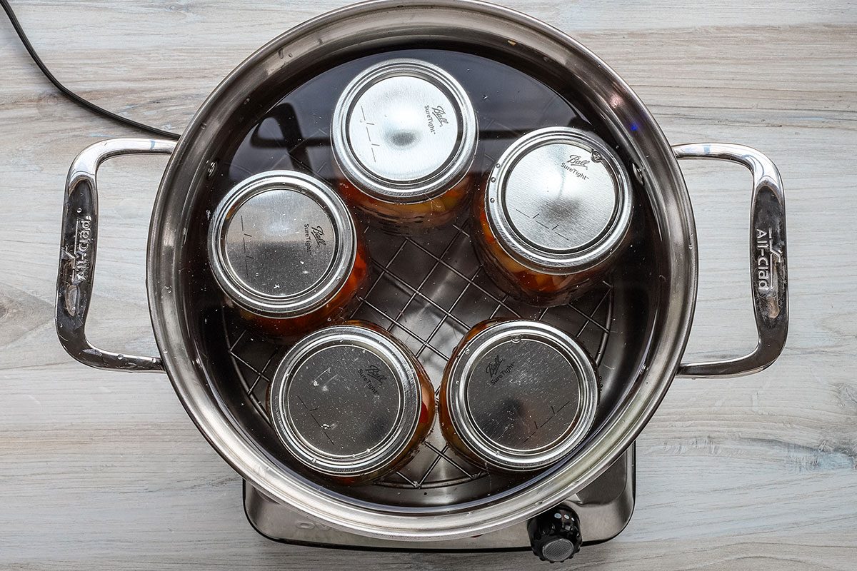 Processing sweet pickled peppers in a boiling water bath.