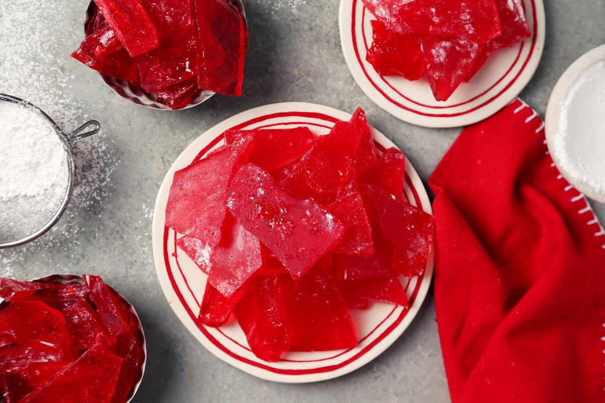 Close up of Taste of Home's cinnamon hard candy in small serving dishes on a grey marble surface.