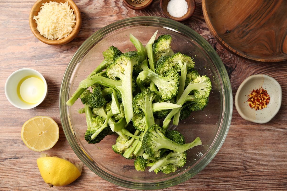 Process of making Taste of Home's Grilled Broccoli grilled and on a plate on a brown wooden surface.