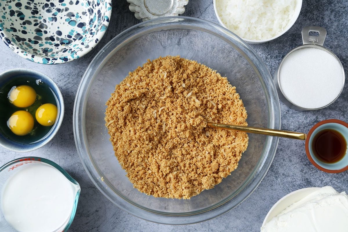 Process of making Taste of Home's Coconut Cheesecake on a dark blue surface.