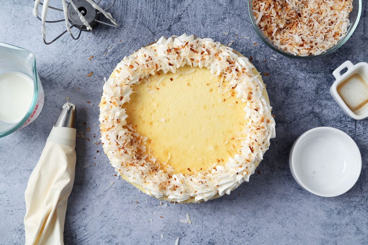 Process of making Taste of Home's Coconut Cheesecake on a dark blue surface.