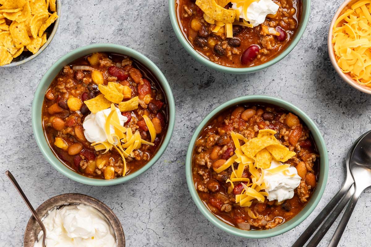 Taco Chili served in a bowl with cheese and sour cream