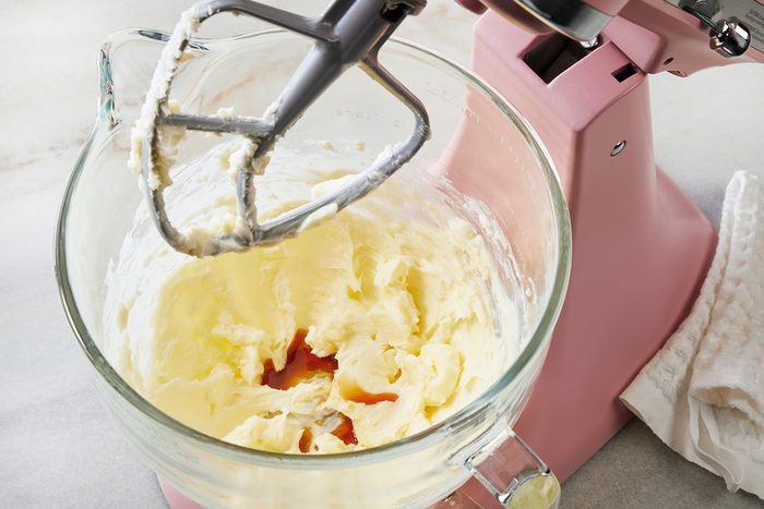 3/4th shot of a large bowl, Beating in vanilla extract with electric beater;