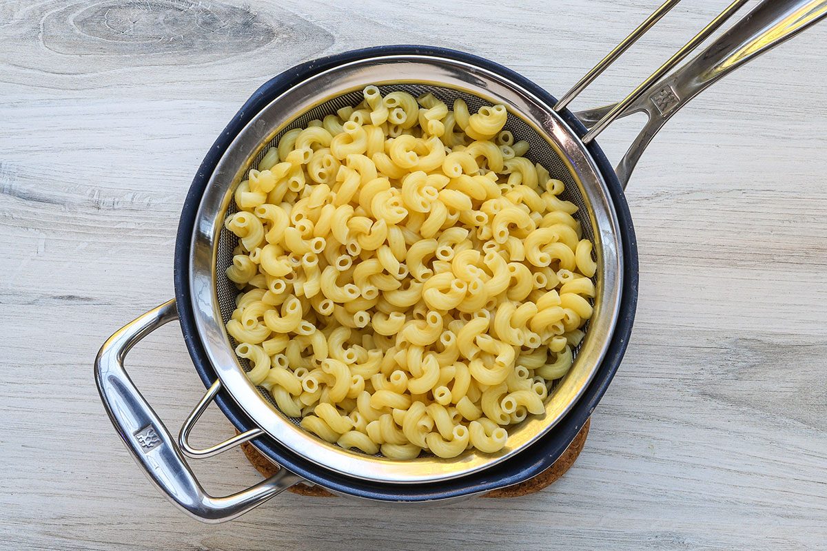 Draining the macaroni for a tuna mac and cheese casserole.