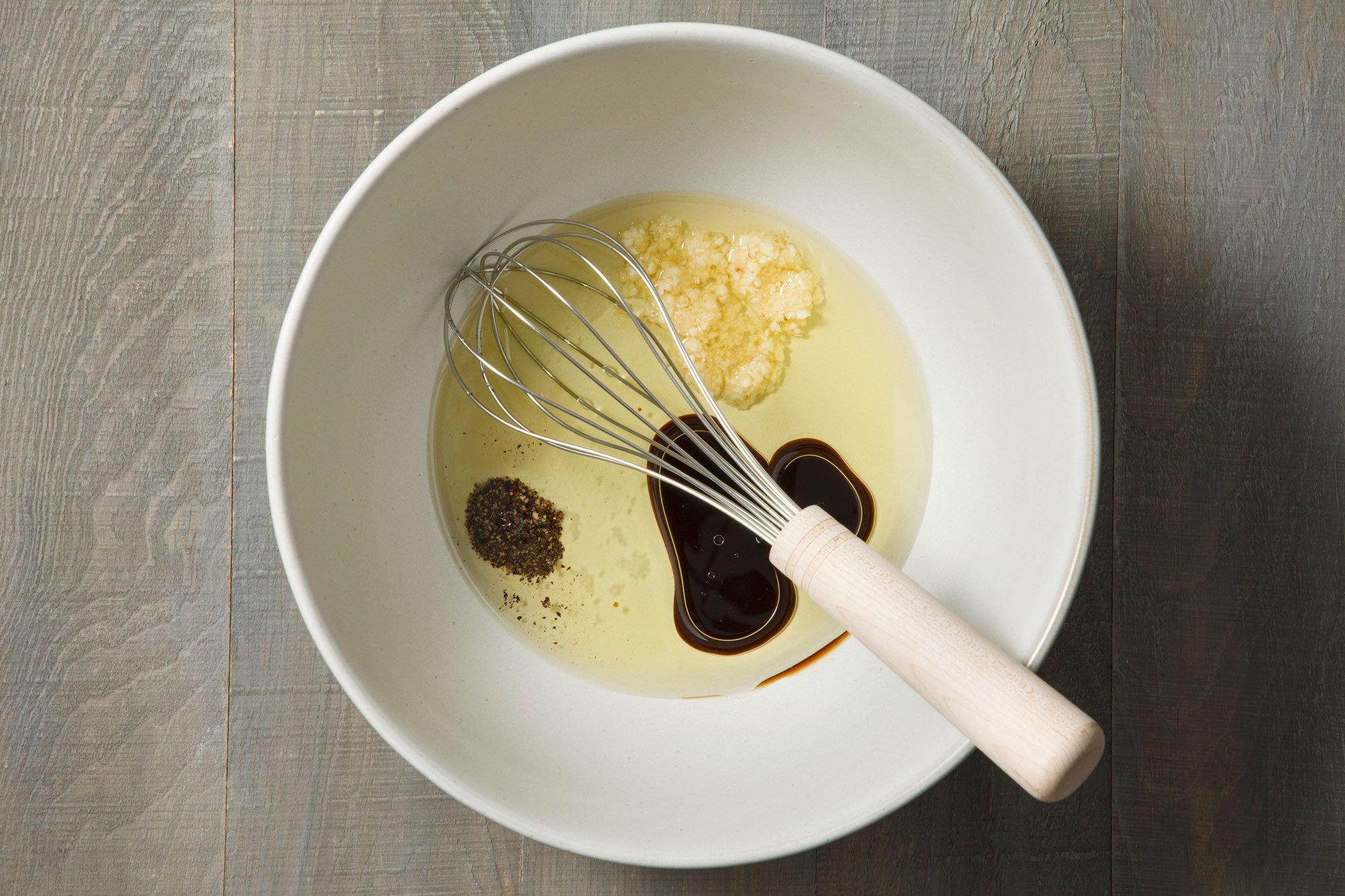 In a large bowl, combine olive oil, Worcestershire, garlic, salt and pepper.